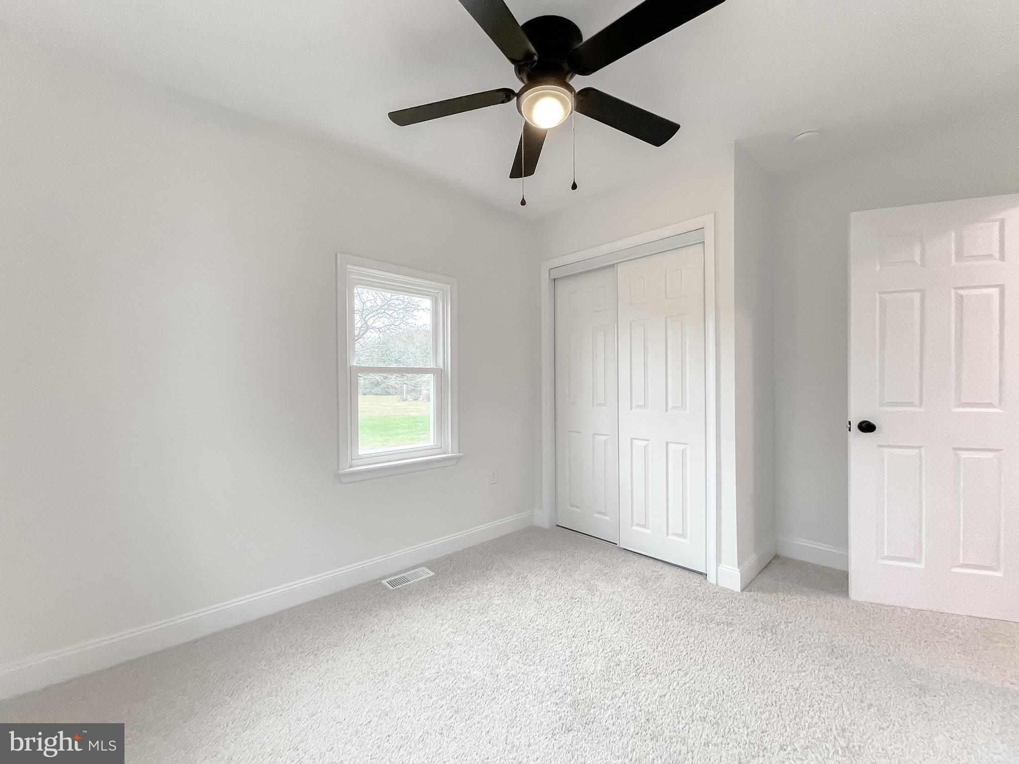 8285 Verne Place Welcome, MD 20693 - Photo 38 of 54 an empty room with a window and a fan