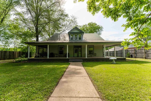a front view of a house with swimming pool having outdoor seating