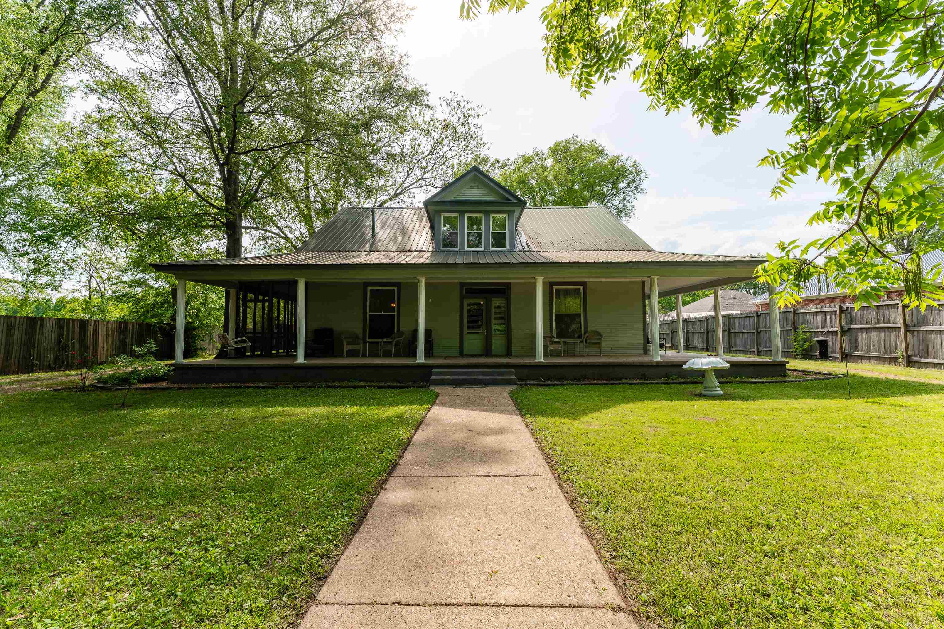 a front view of a house with swimming pool having outdoor seating