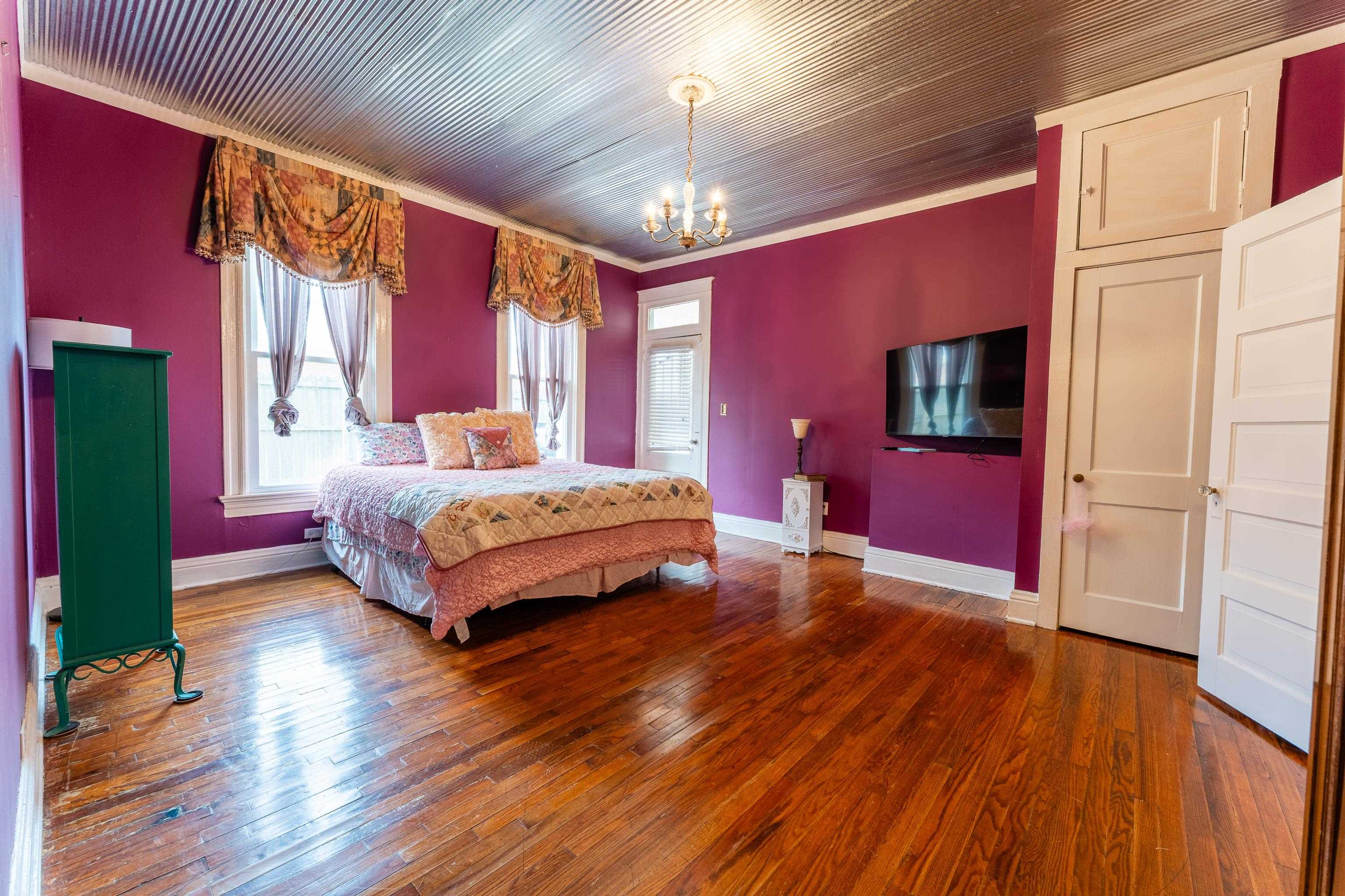 171 White Street Savannah, TN 38372 - Photo 14 of 36 a bedroom with a bed chandelier and a window