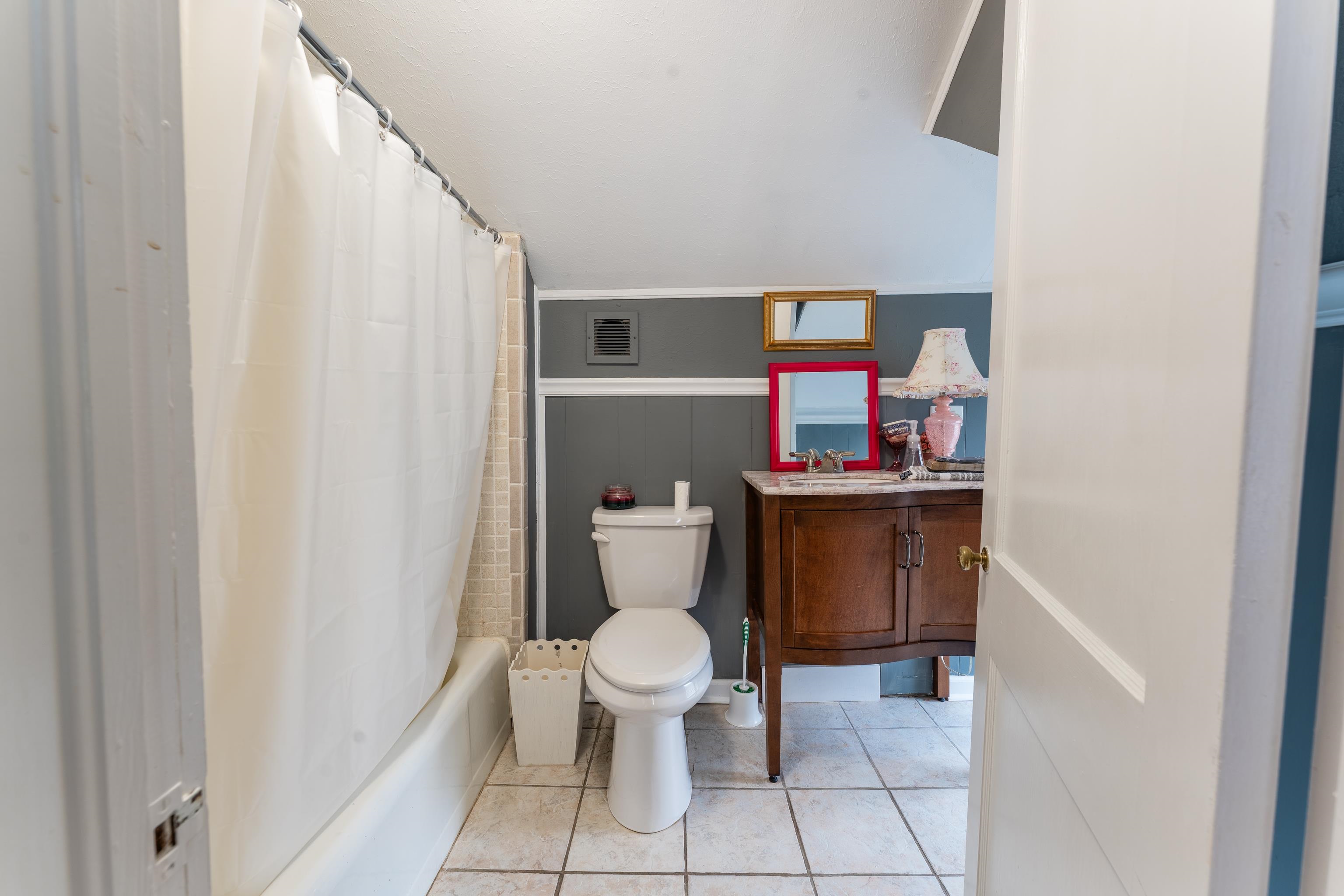 171 White Street Savannah, TN 38372 - Photo 24 of 36 a white toilet sitting next to a white sink and vanity