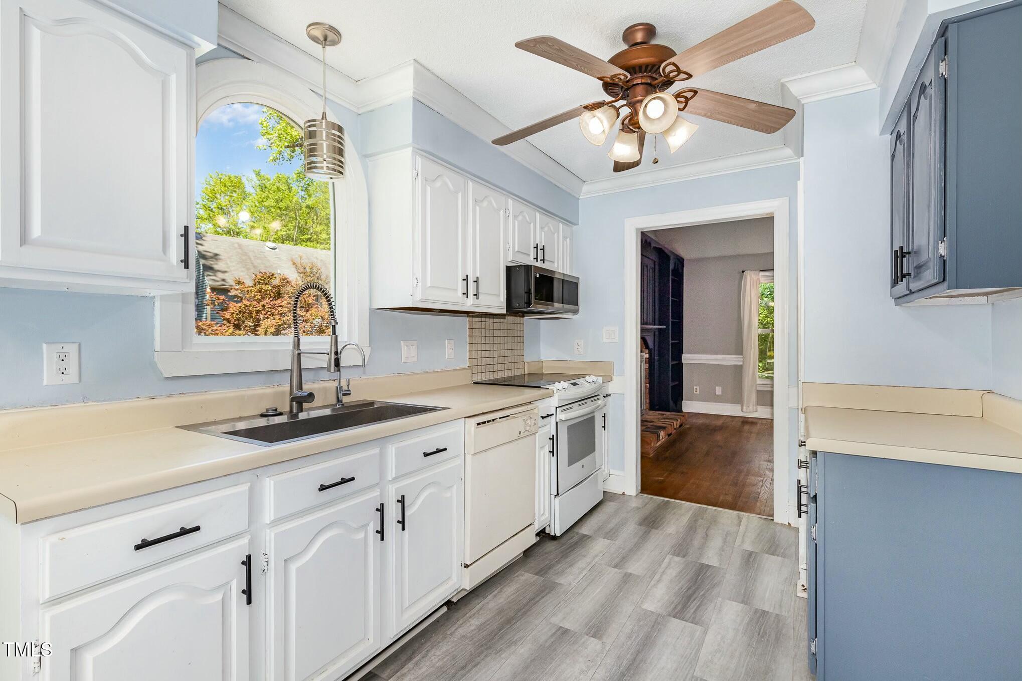 3109 East Folkestone Place Raleigh, NC 27604 - Photo 11 of 25 a kitchen with sink cabinets and window