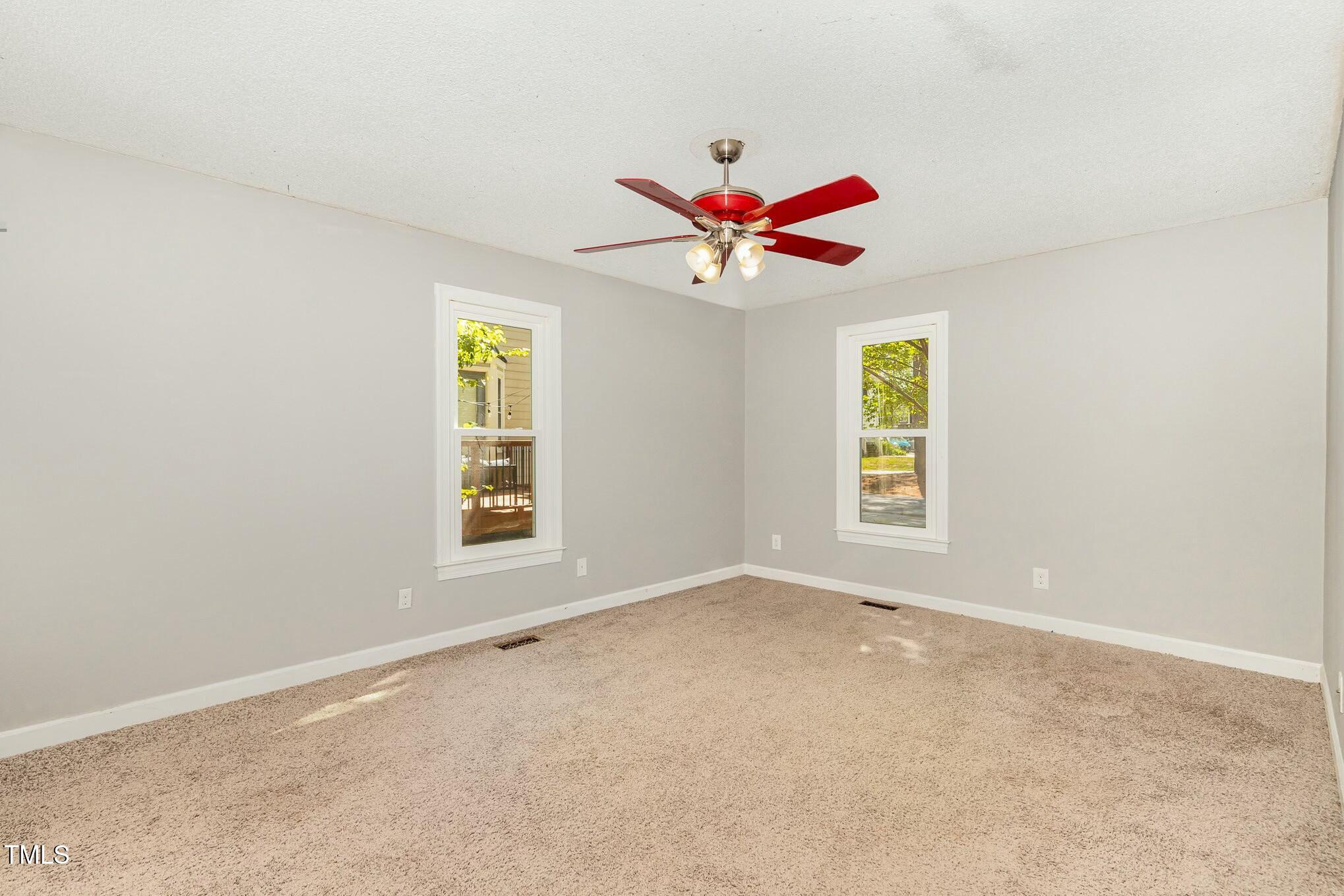 3109 East Folkestone Place Raleigh, NC 27604 - Photo 12 of 25 an empty room with windows and fan