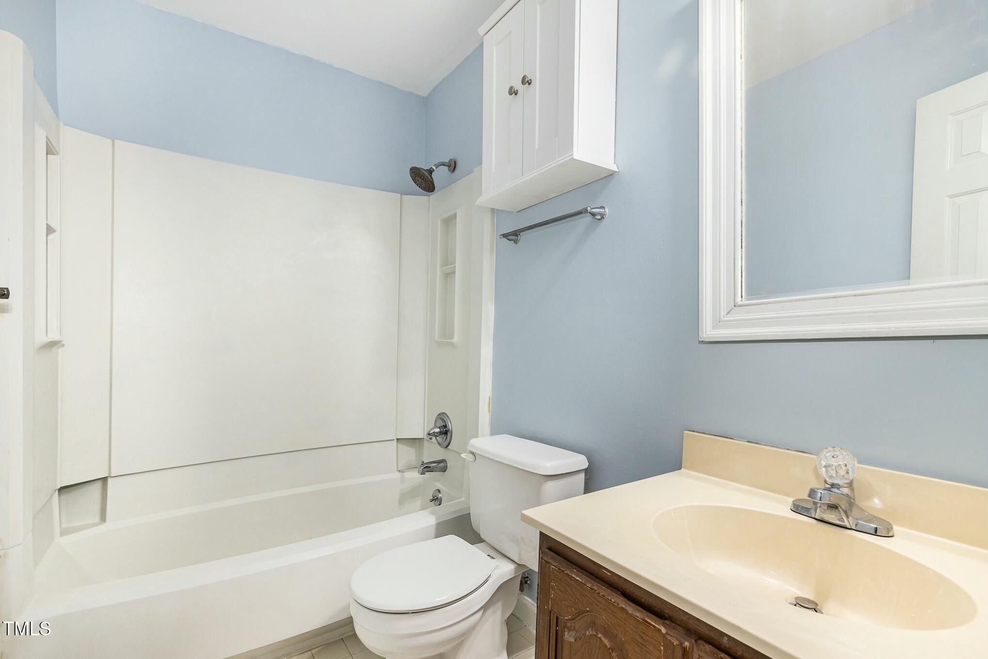 3109 East Folkestone Place Raleigh, NC 27604 - Photo 17 of 25 a bathroom with a sink toilet and shower