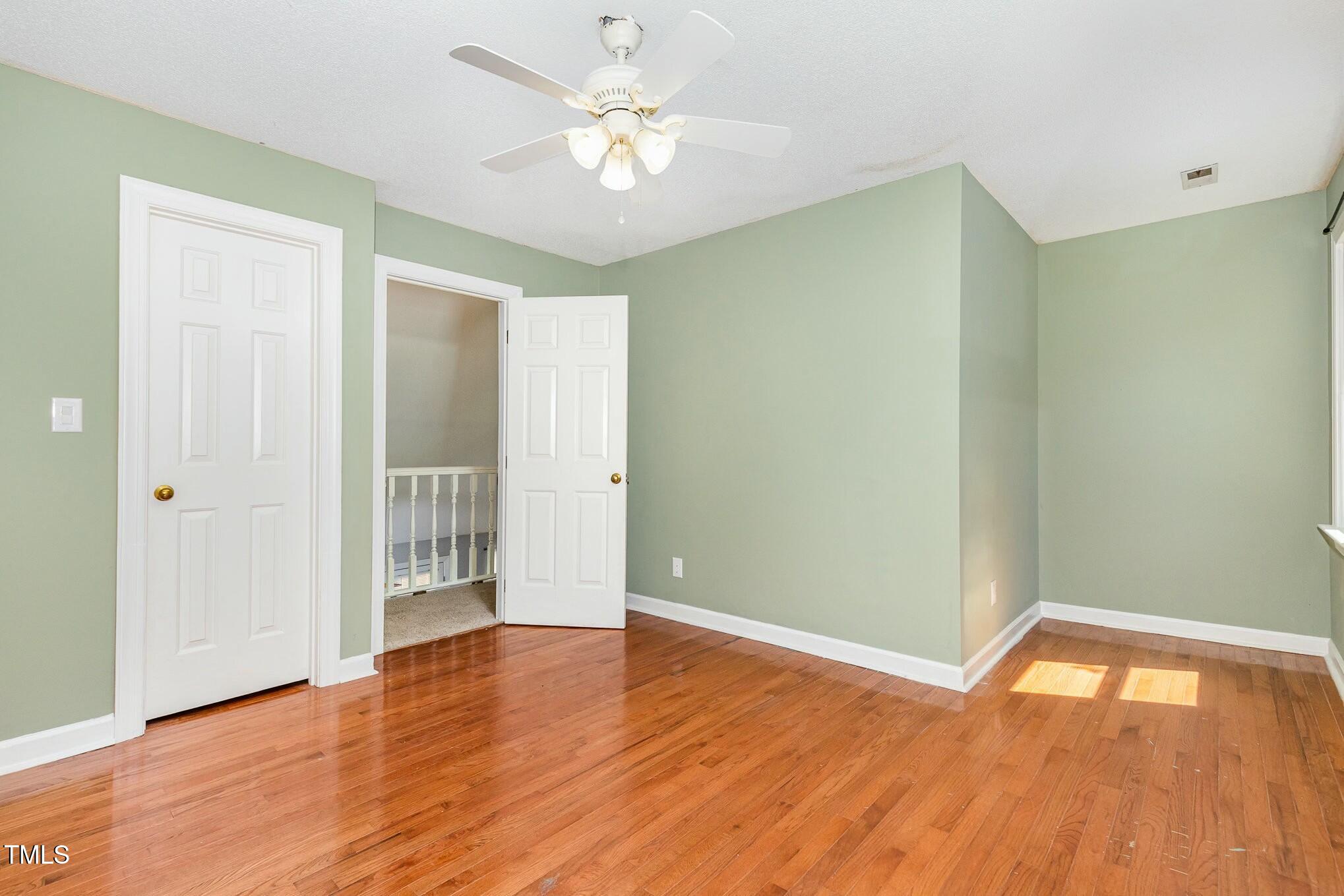 3109 East Folkestone Place Raleigh, NC 27604 - Photo 18 of 25 an empty room with wooden floor and windows
