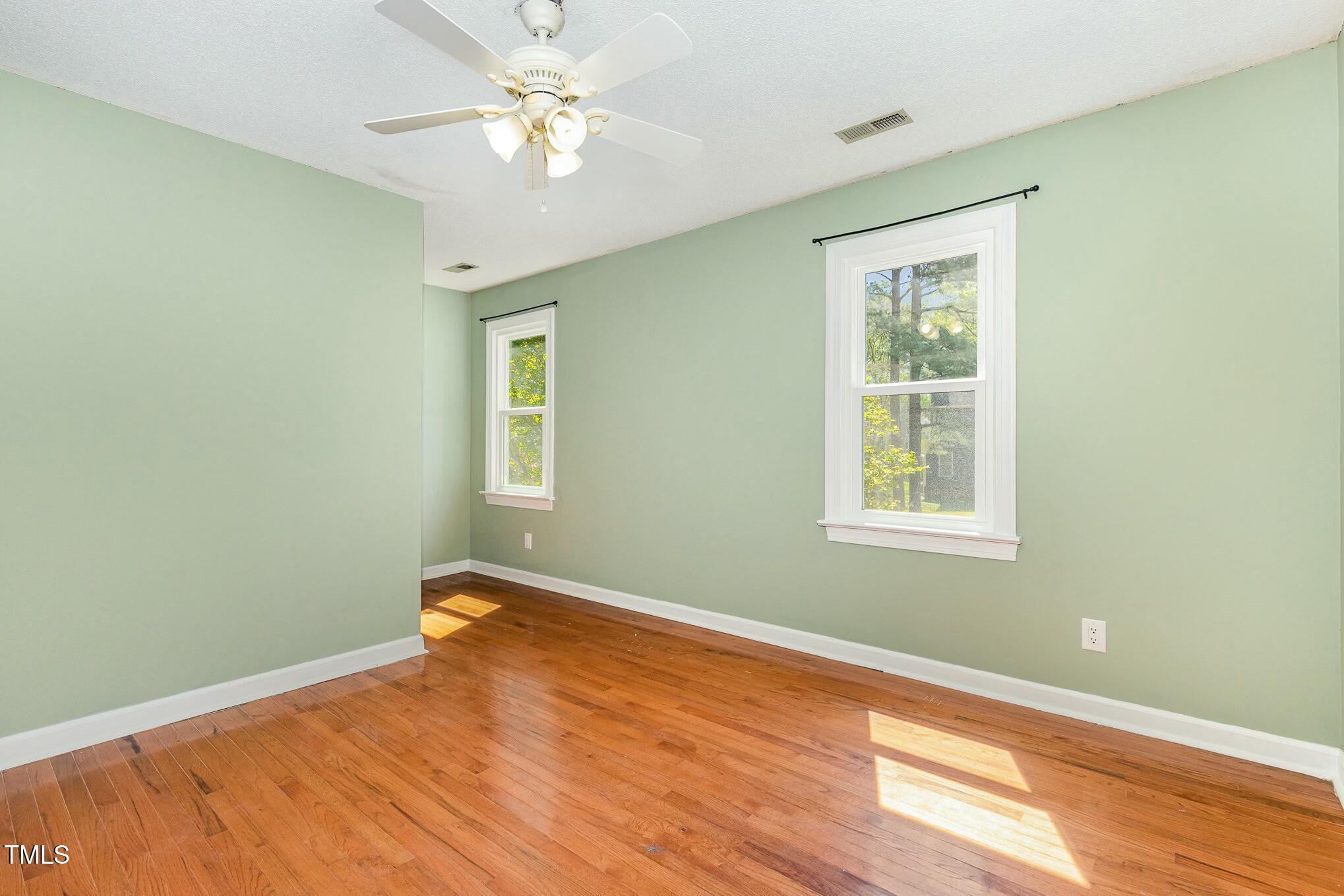 3109 East Folkestone Place Raleigh, NC 27604 - Photo 19 of 25 a view of a room with a ceiling fan and a window