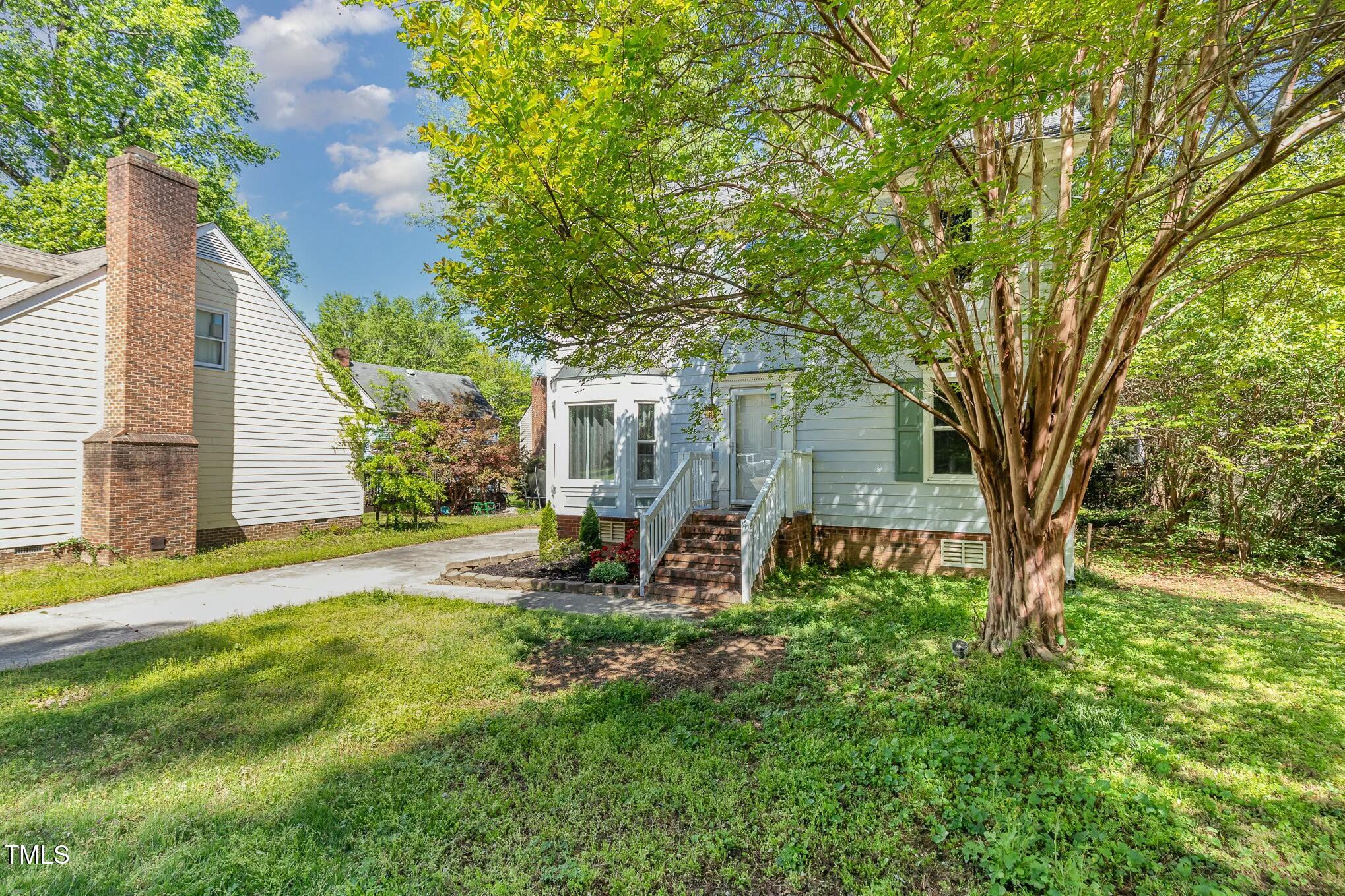 3109 East Folkestone Place Raleigh, NC 27604 - Photo 2 of 25 a view of backyard of house with green space and seating area