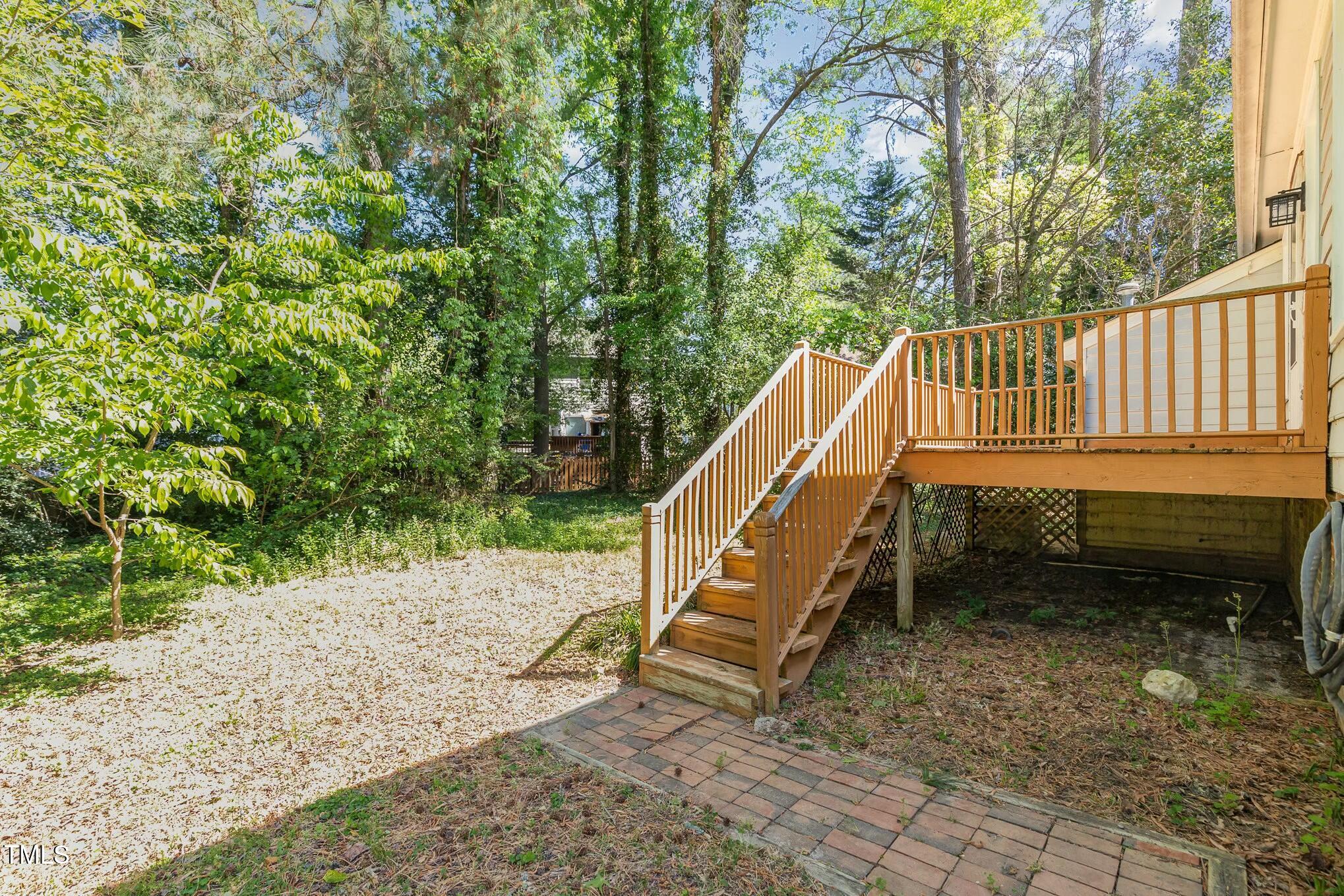3109 East Folkestone Place Raleigh, NC 27604 - Photo 22 of 25 a view of a roof deck with wooden fence and a bench