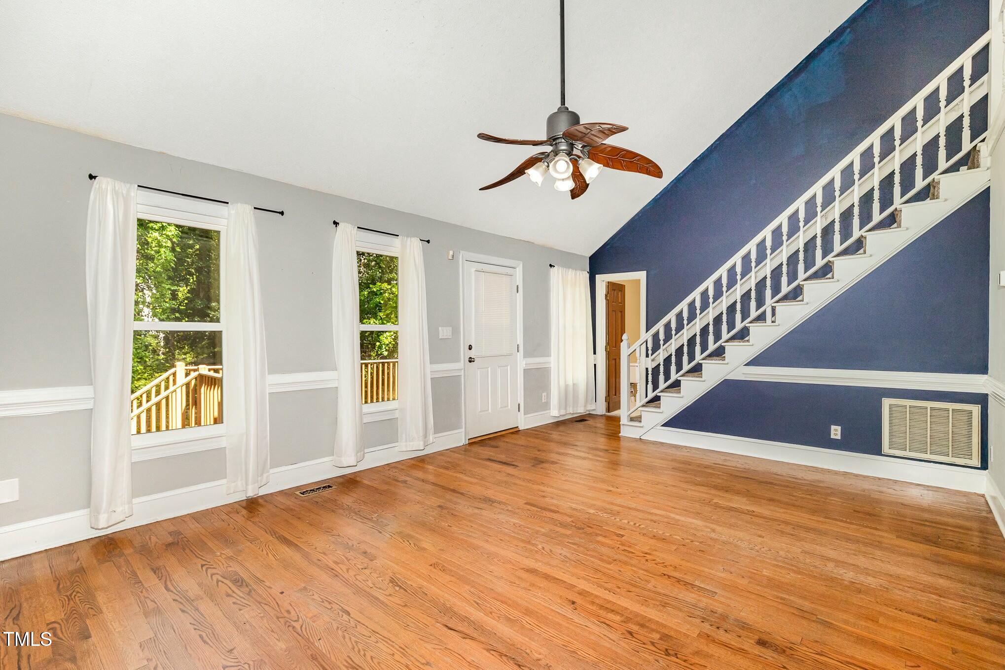 3109 East Folkestone Place Raleigh, NC 27604 - Photo 5 of 25 a view of an empty room with wooden floor and a window