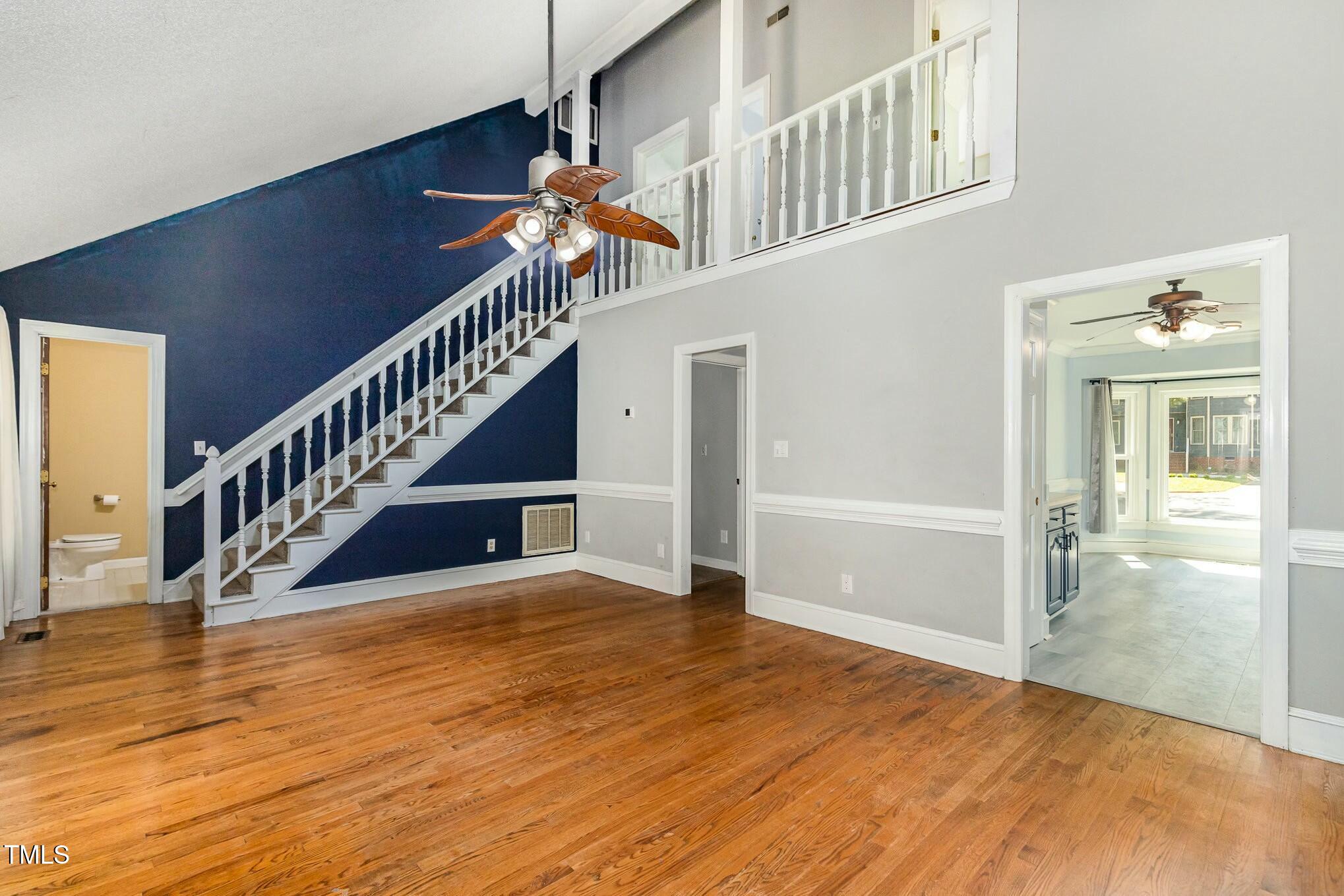 3109 East Folkestone Place Raleigh, NC 27604 - Photo 6 of 25 a view of a hallway with an entryway and wooden floor