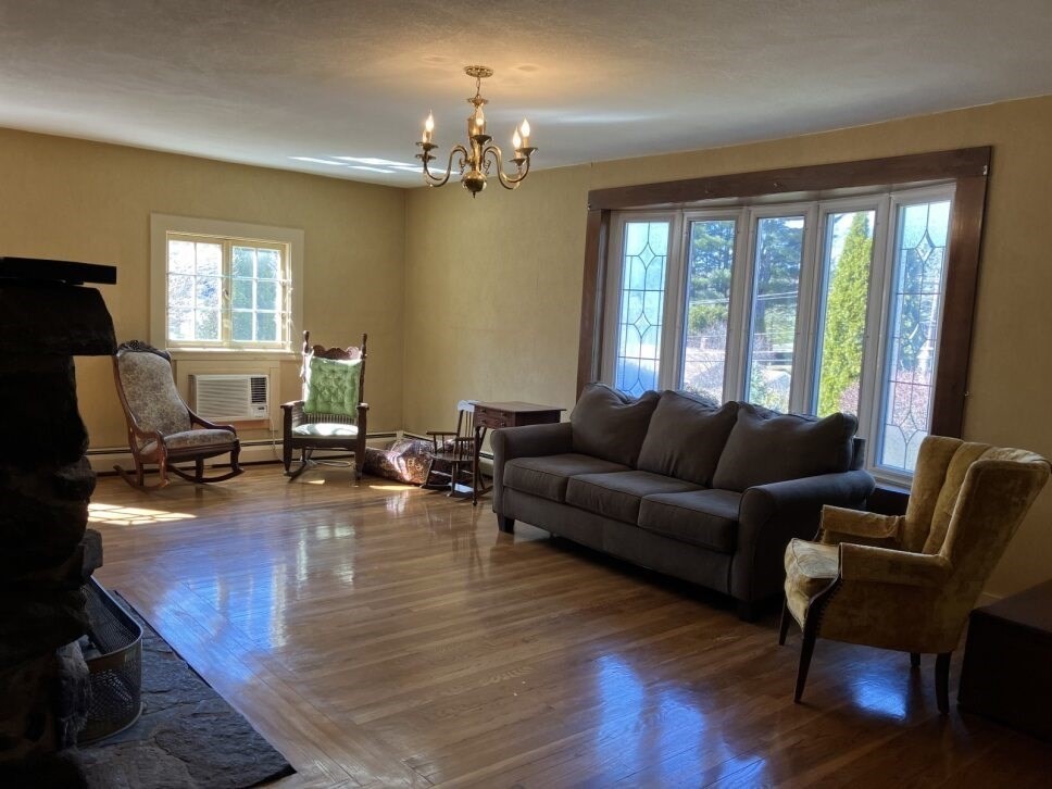 9 Brimfield Road Monson, MA 01057 - Photo 13 of 27 a living room with furniture and a chandelier