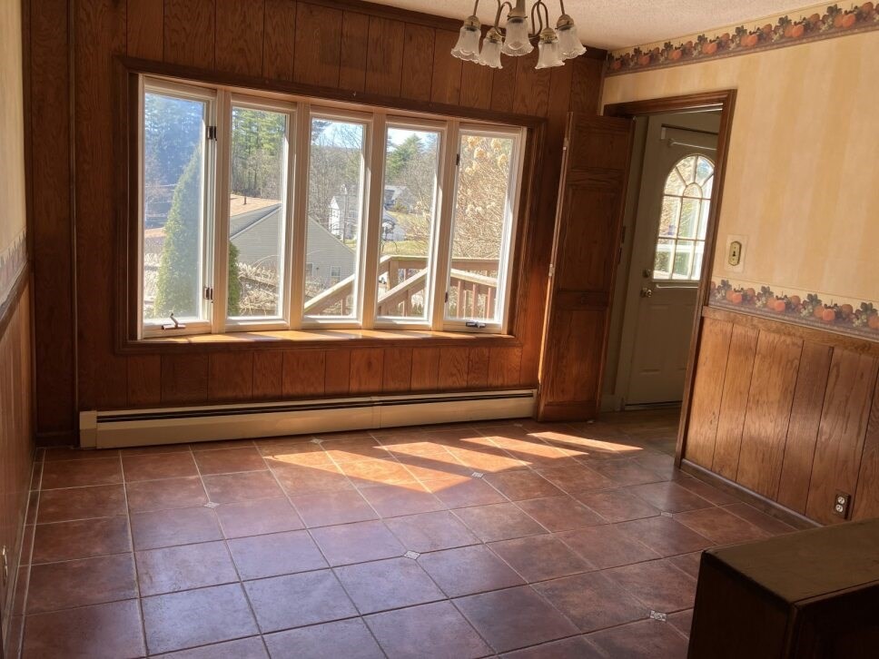 9 Brimfield Road Monson, MA 01057 - Photo 5 of 27 a view of an empty room with a fireplace and a window