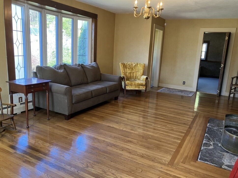9 Brimfield Road Monson, MA 01057 - Photo 9 of 27 a living room with furniture and a large mirror next to a window