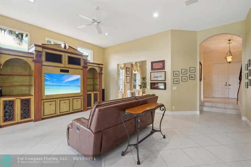 2515 Montclaire Circle Weston, FL 33327 - Photo 13 of 51 a living room with furniture a flat screen tv and a refrigerator