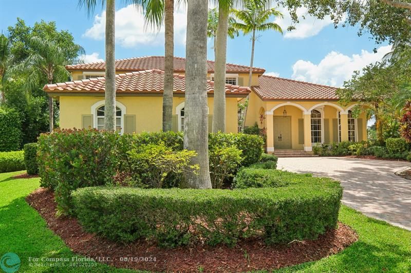 2515 Montclaire Circle Weston, FL 33327 - Photo 2 of 51 a front view of a house with a garden