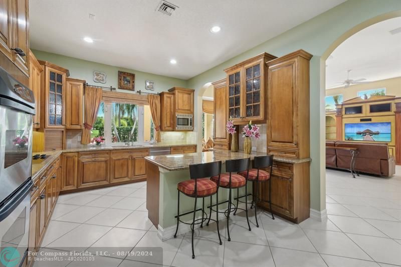 2515 Montclaire Circle Weston, FL 33327 - Photo 5 of 51 a kitchen with stainless steel appliances a stove a sink a oven a dining table and chairs