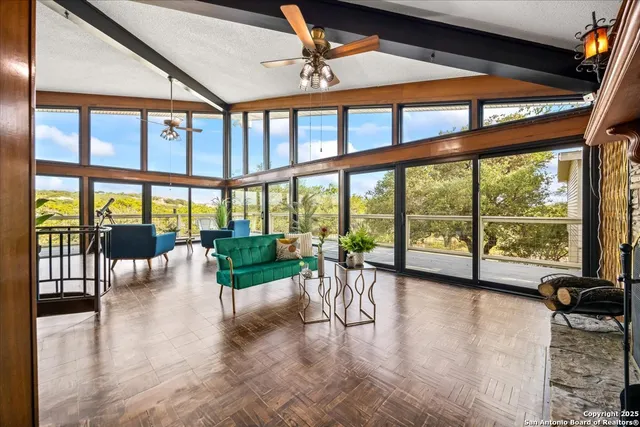a view of a work space with furniture and floor to ceiling windows