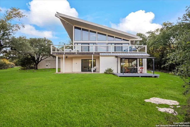 a view of a house with a yard and sitting area