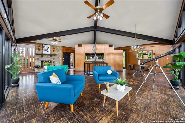 an aerial view of residential houses with outdoor space and trees