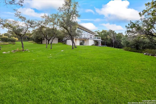 a view of a house with a yard and sitting area