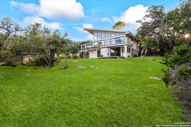 a front view of a house with a yard garage and outdoor seating
