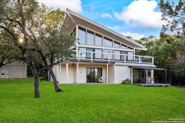 an aerial view of a house with a mountain in the background