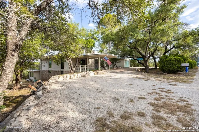 an aerial view of a house with a yard basket ball court and outdoor seating