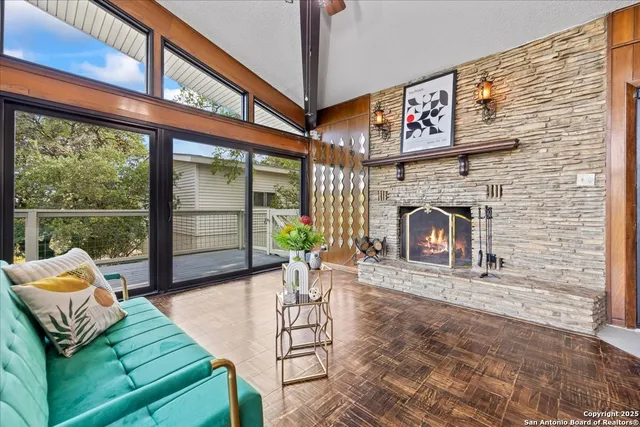a view of a dining room with furniture a chandelier and wooden floor