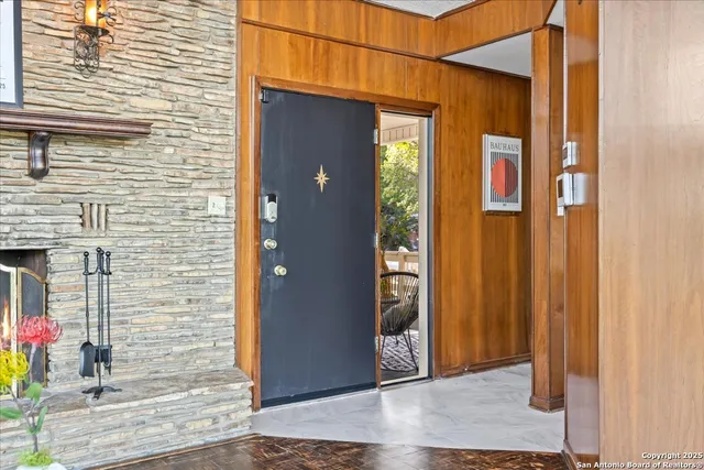 a bathroom with a granite countertop toilet sink and mirror