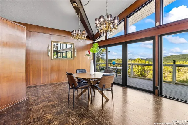 a view of a chair and table on the wooden deck