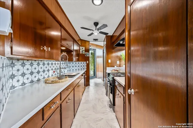 a view of a porch with wooden floor and iron fence
