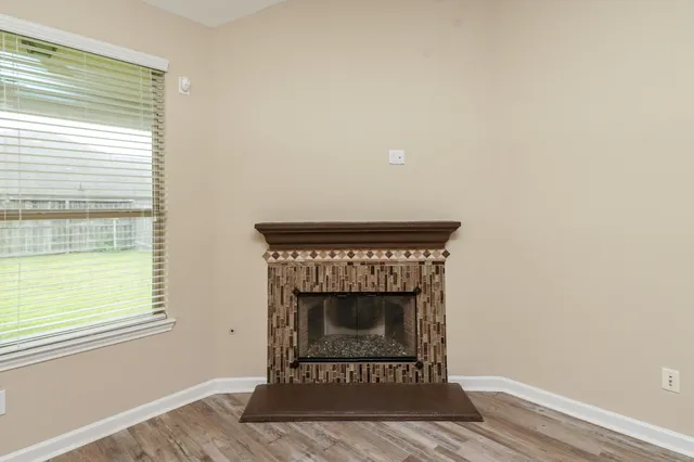a living room with a fireplace and a window