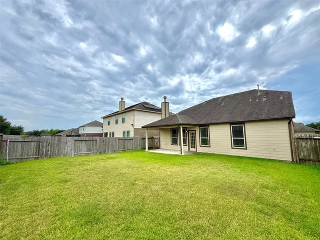 a view of a house with a yard and sitting area