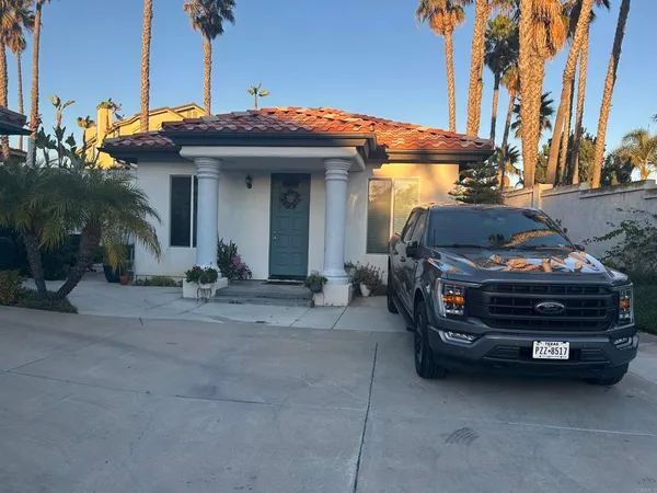 a front view of a house with parking space