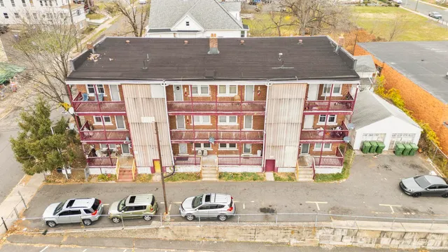 a front view of a residential apartment building with a yard