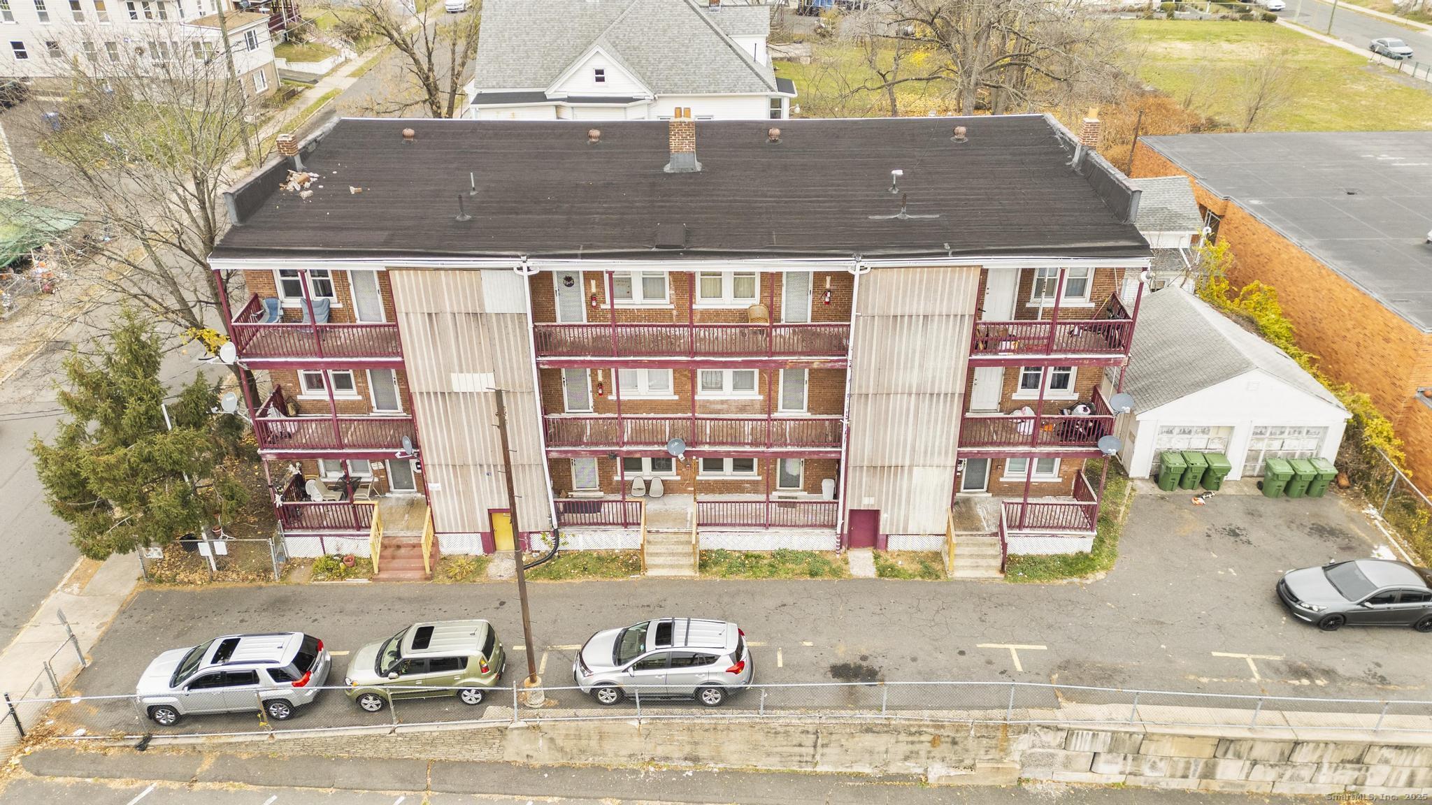 75 Clark Street New Britain, CT 06051 - Photo 2 of 14 a front view of a residential apartment building with a yard