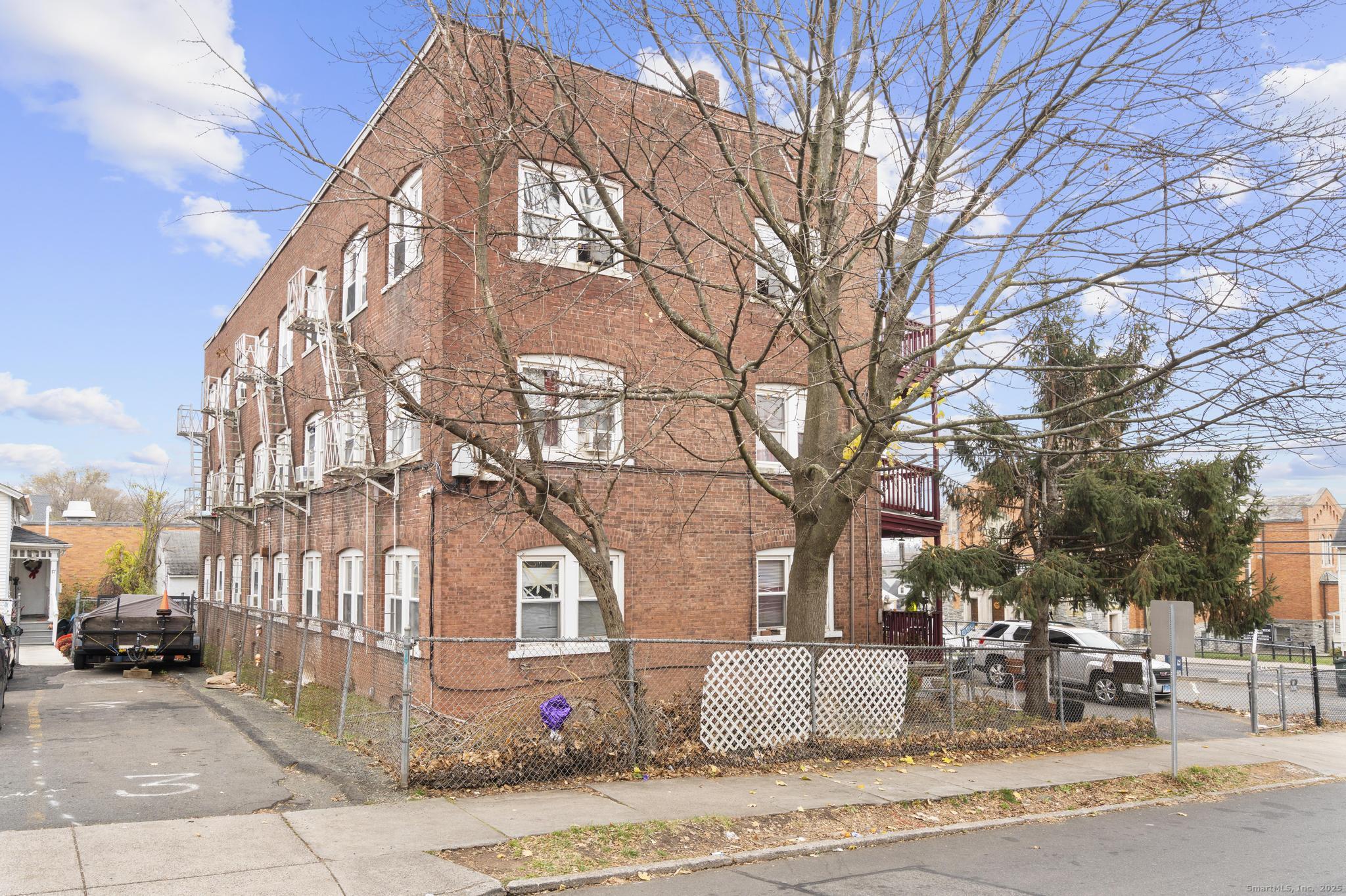 75 Clark Street New Britain, CT 06051 - Photo 6 of 14 a view of a building with a yard