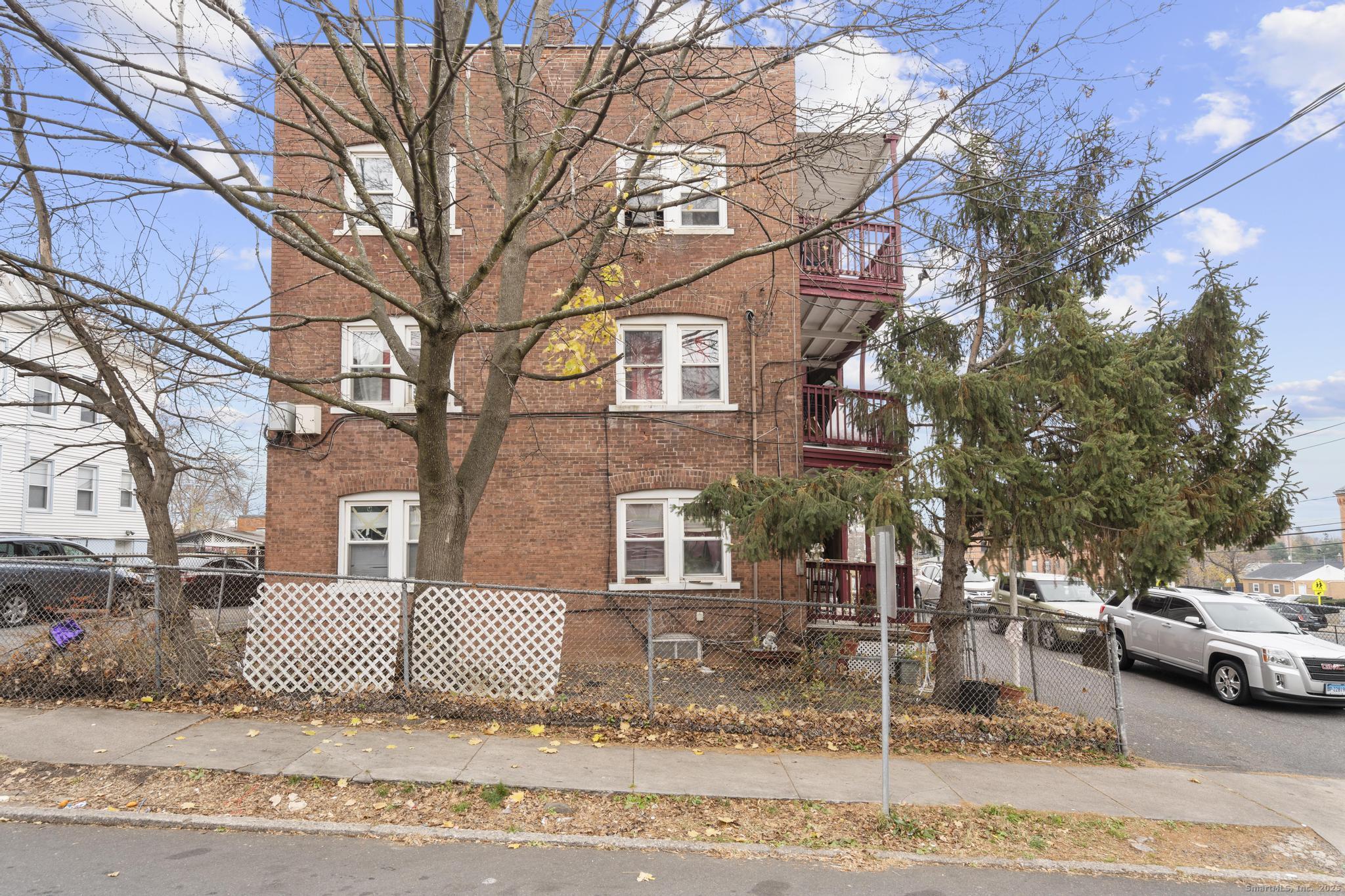 75 Clark Street New Britain, CT 06051 - Photo 7 of 14 a view of a brick house with many windows