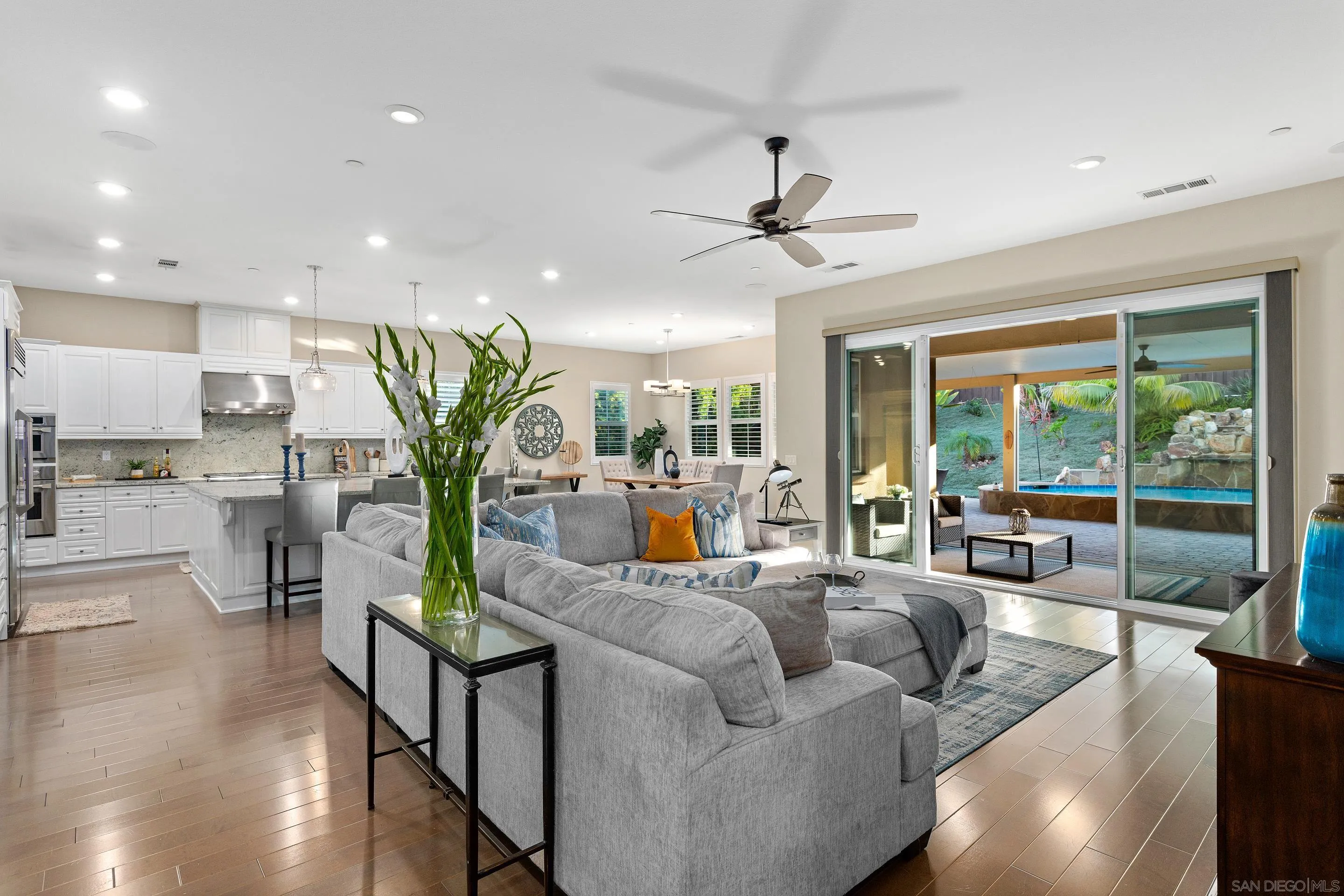 a living room with furniture and a view of kitchen