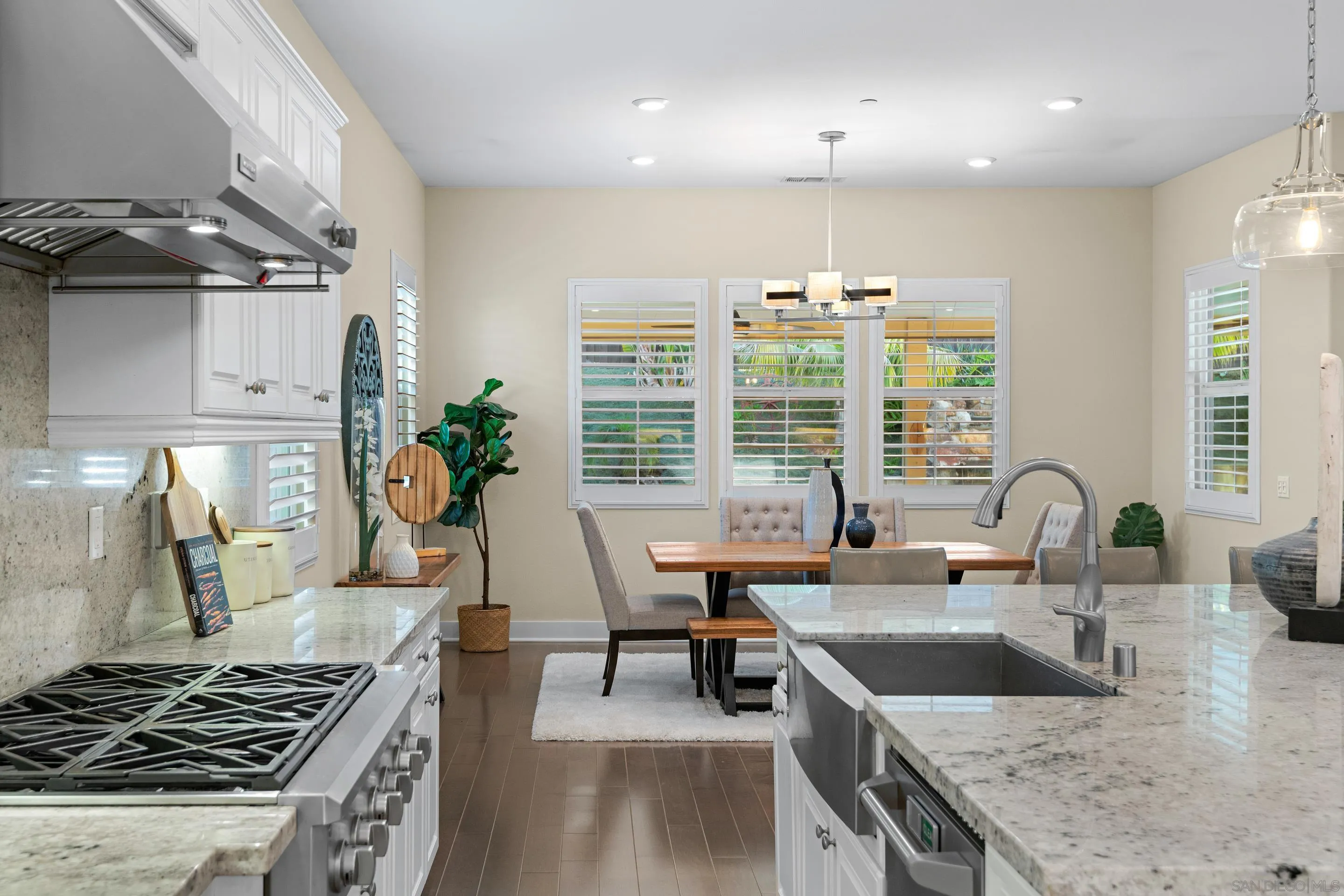 5401 Reef Circle Carlsbad, CA 92008 - Photo 13 of 45 a kitchen with granite countertop a stove and a sink