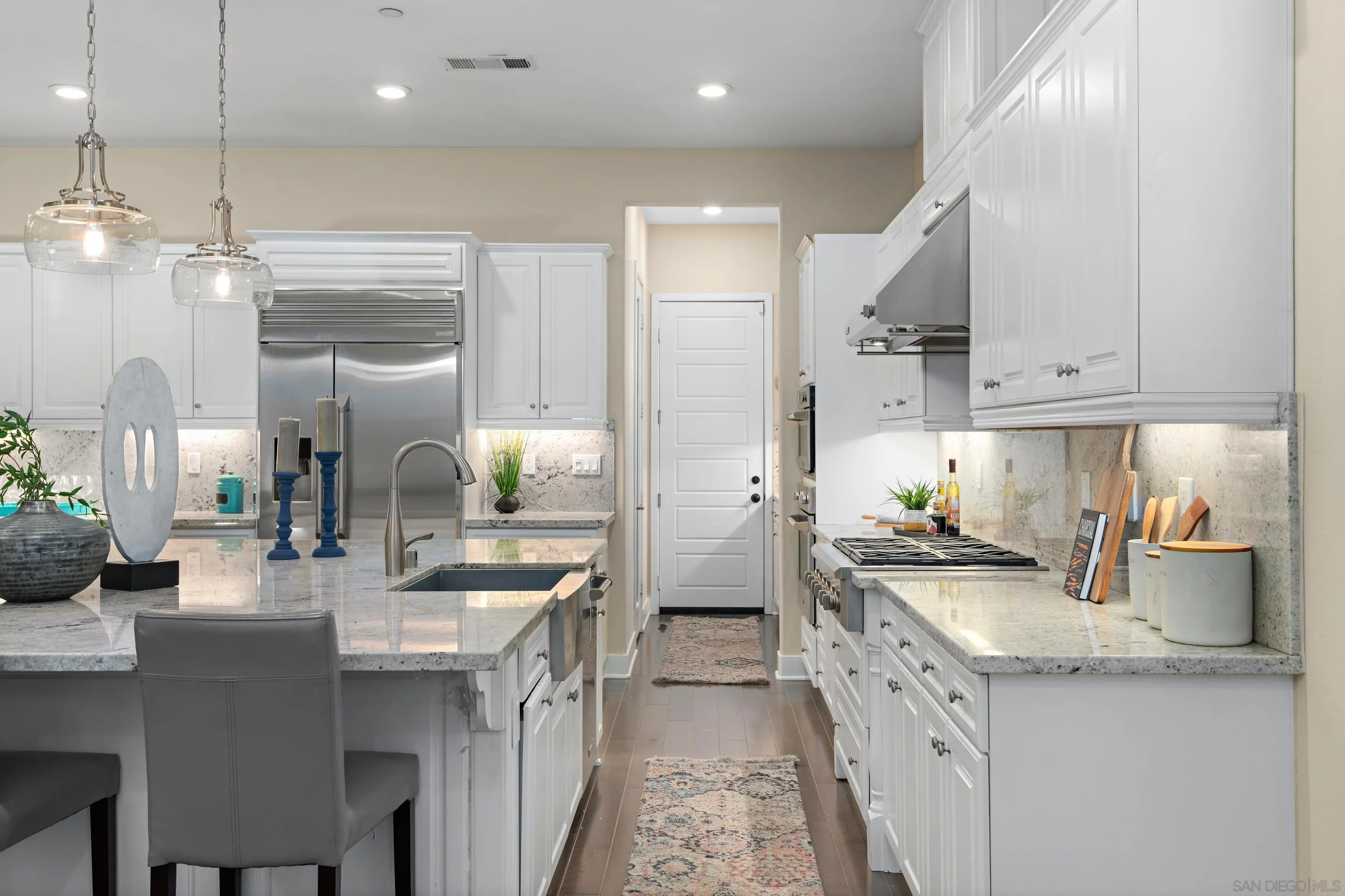5401 Reef Circle Carlsbad, CA 92008 - Photo 16 of 45 a kitchen with kitchen island granite countertop a sink a counter top space and stainless steel appliances