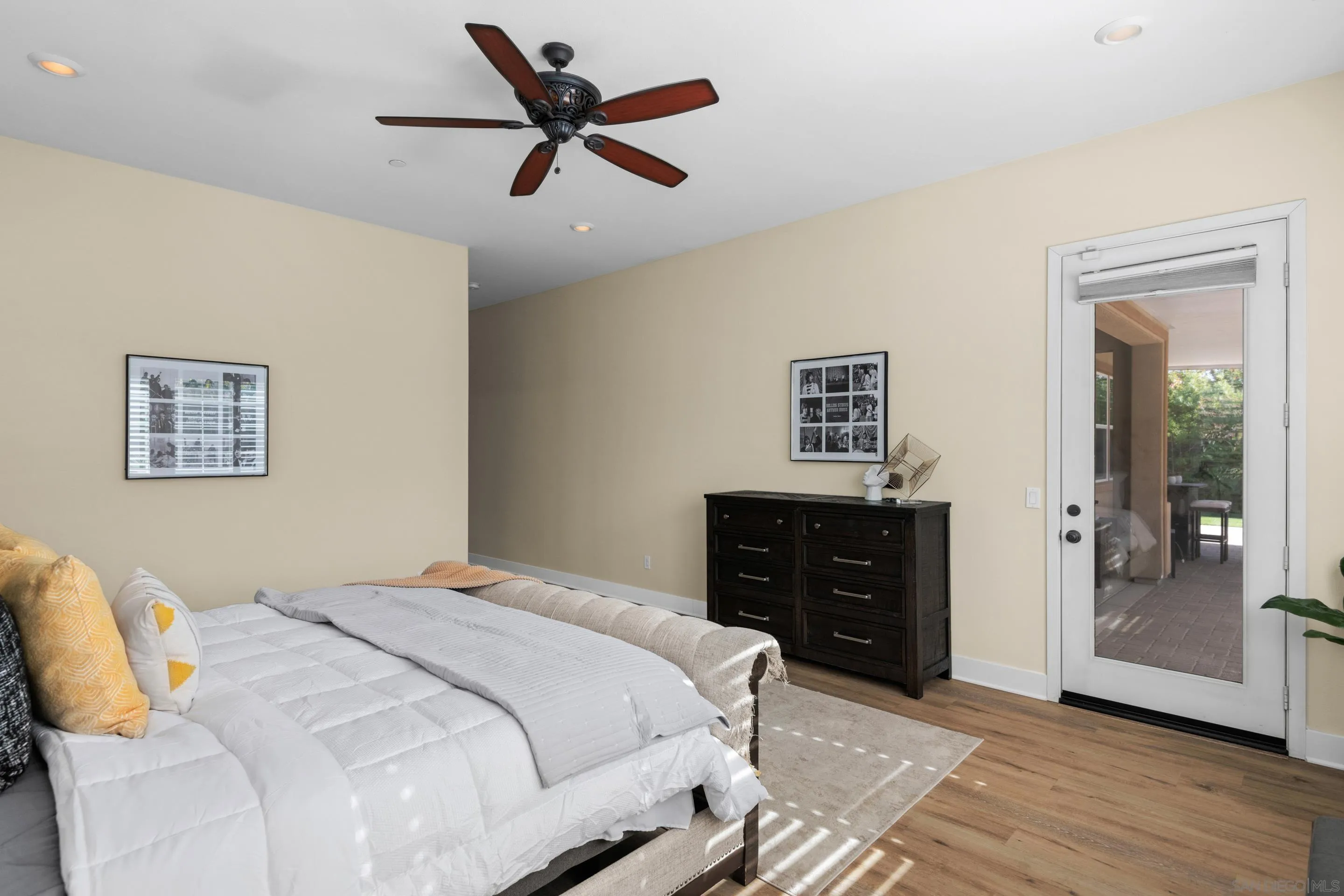 5401 Reef Circle Carlsbad, CA 92008 - Photo 23 of 45 a bedroom with a bed and wooden floor