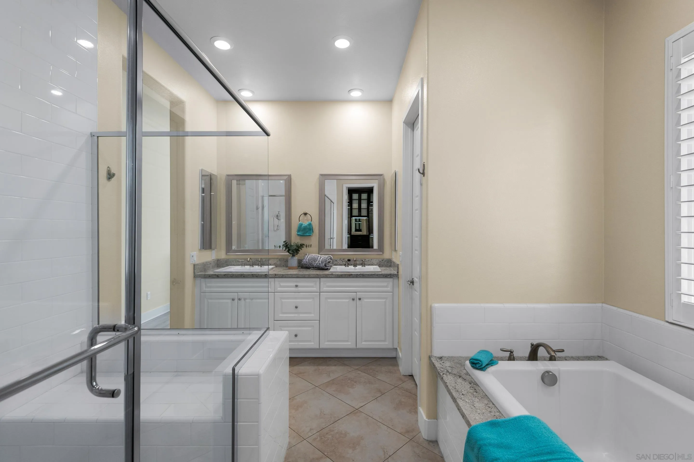 5401 Reef Circle Carlsbad, CA 92008 - Photo 26 of 45 a bathroom with a tub sink and mirror