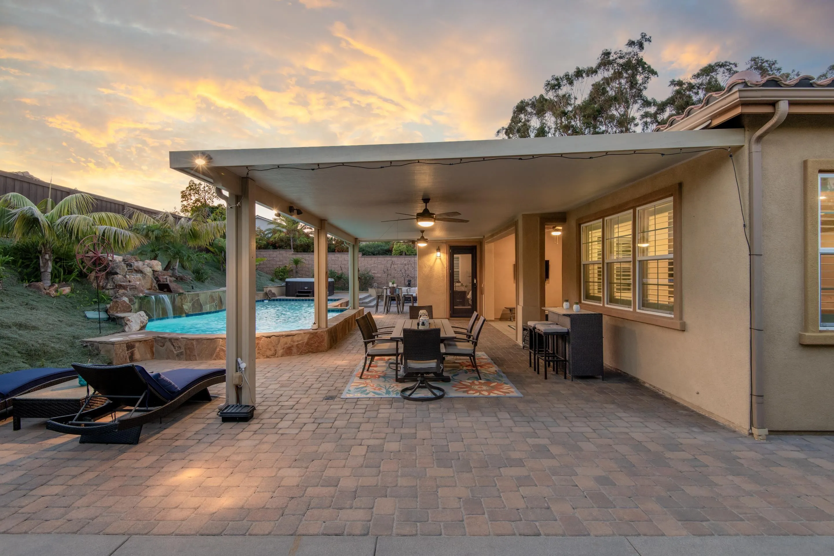 5401 Reef Circle Carlsbad, CA 92008 - Photo 42 of 45 a view of a patio with table and chairs next to a yard