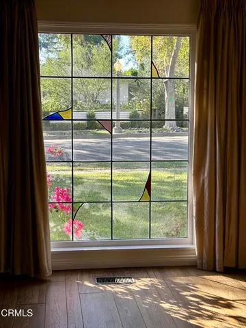 a view of a room with wooden floor and a porch