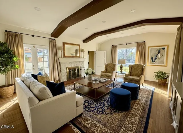 a living room with furniture potted plant and a large window