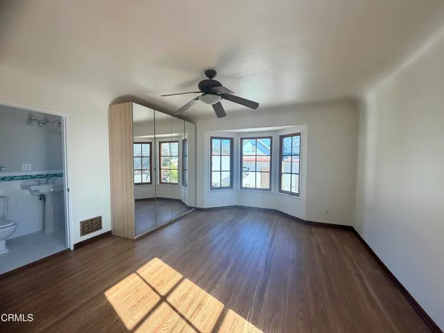 a dining room with furniture window and wooden floor