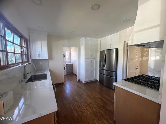 a stove top oven sitting inside of a kitchen