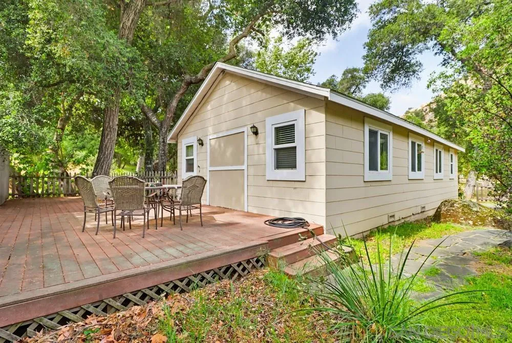 2275 Honey Springs Road Jamul, CA 91935 - Photo 17 of 17 a view of a patio with table and chairs with wooden floor and fence