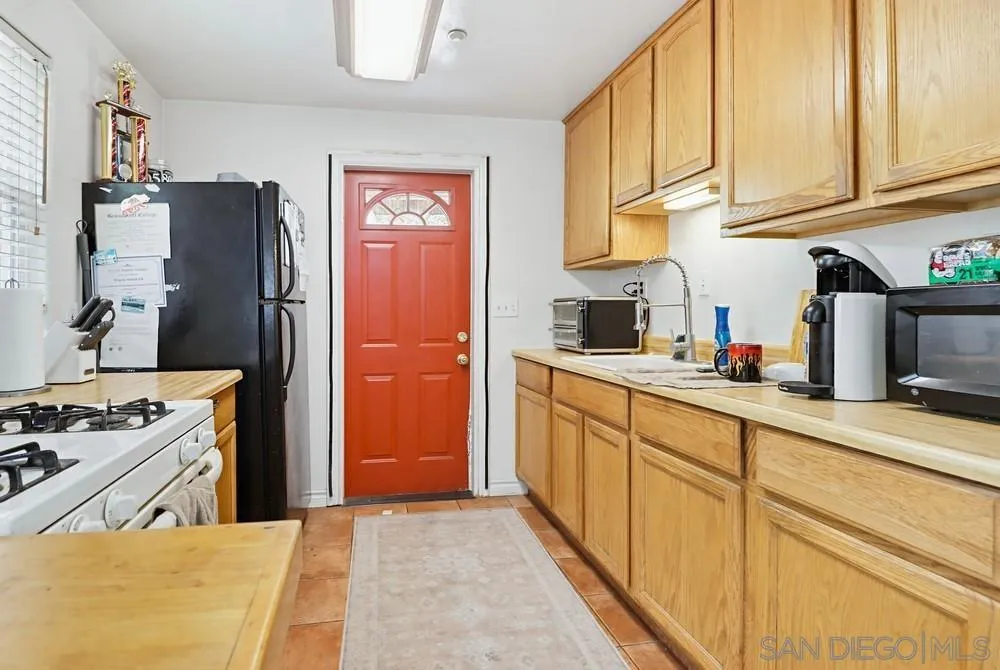 2275 Honey Springs Road Jamul, CA 91935 - Photo 5 of 17 a kitchen with stainless steel appliances granite countertop a refrigerator and a stove top oven